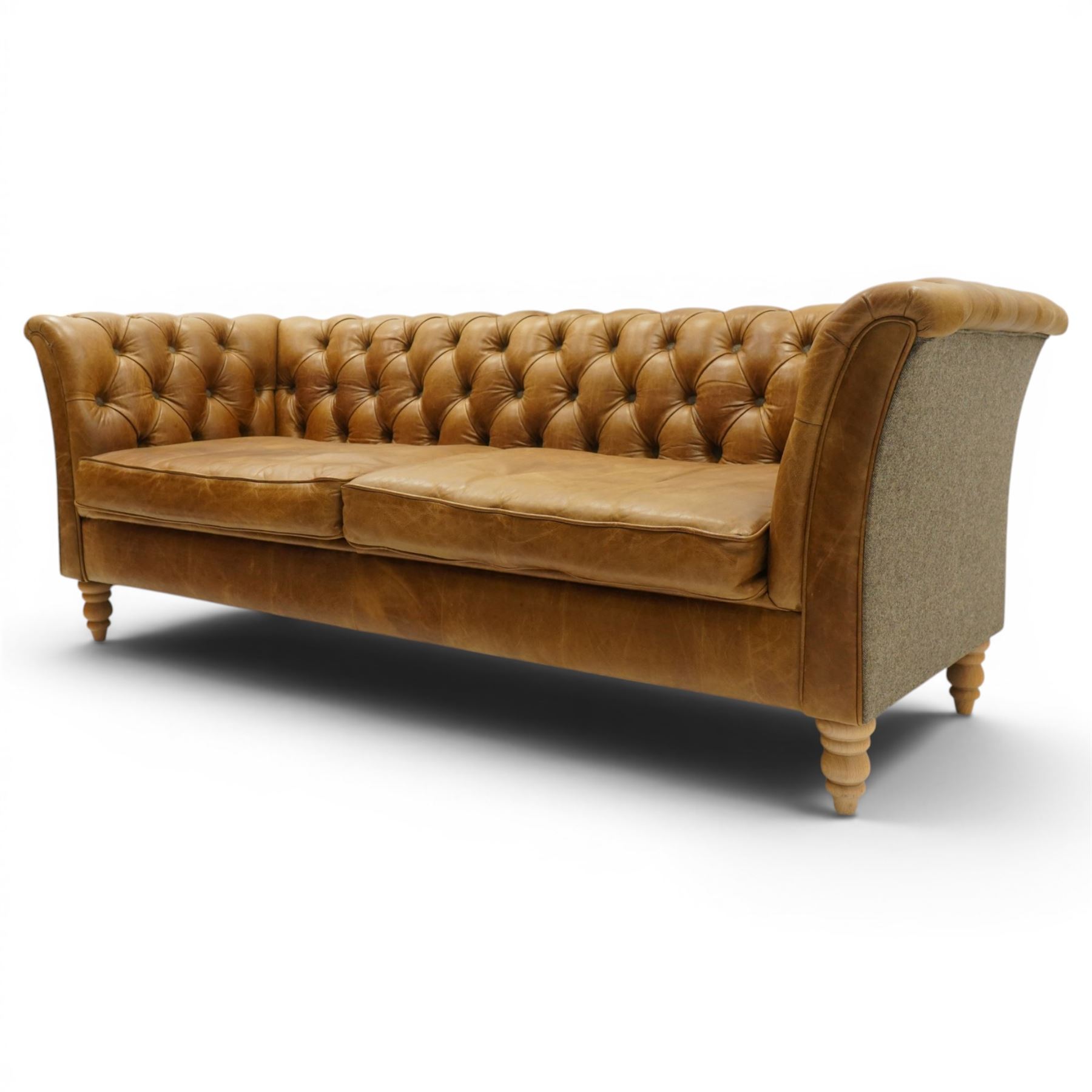 Contemporary Chesterfield design 'Caesar' three seat sofa, traditional shape with out-swept arms, upholstered in tan leather with loose seat cushions, the back, sides and buttons upholstered in chevron stitched Harris Tweed, on turned feet