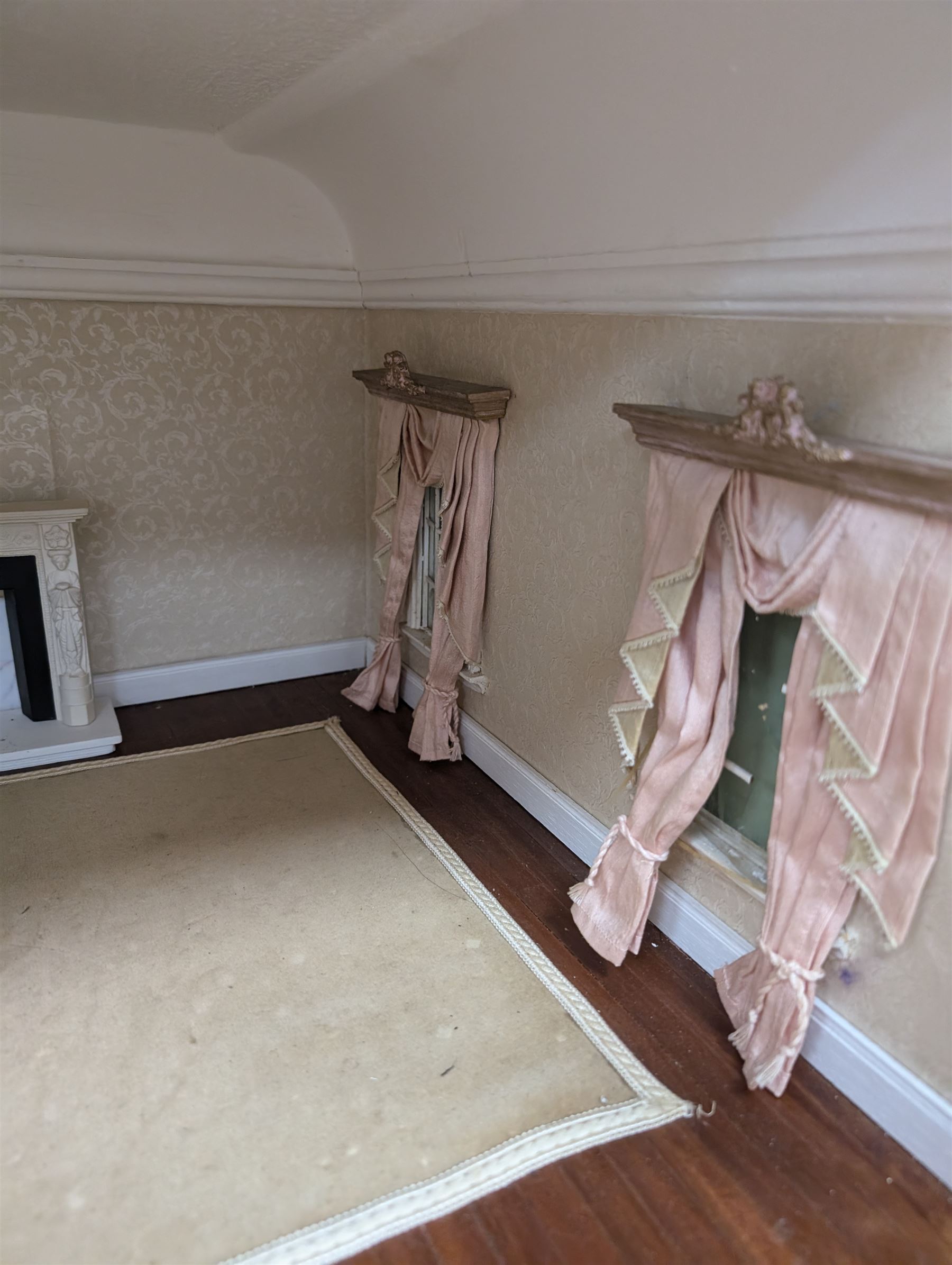 Two modern three storey dolls houses, each painted green with decorated interiors, both upon a single white wooden base, together with a large collection of dolls house furniture, accessories and figures 