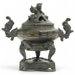19th century Chinese two handled bronze koro, the pierced cover with a seated Buddhistic l...