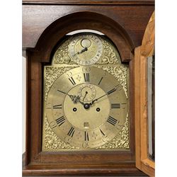 John Greaves of Newcastle - Mid-18th century 8-day oak longcase clock with a flat top, double cornice and break arch hood door flanked by two turned pilasters, trunk with canted corners and a spire topped door with crossbanding, rectangular plinth raised on bracket feet, brass dial with cast spandrels and penny-moon dial and pointer to the arch, matted dial centre with a silvered chapter ring and seconds ring, chapter with Roman numerals, five minute Arabic's, minute and quarter tracks, square date aperture and fettled steel hands, dial pinned to a rack striking movement with a recoil anchor escapement. With pendulum and weights.
