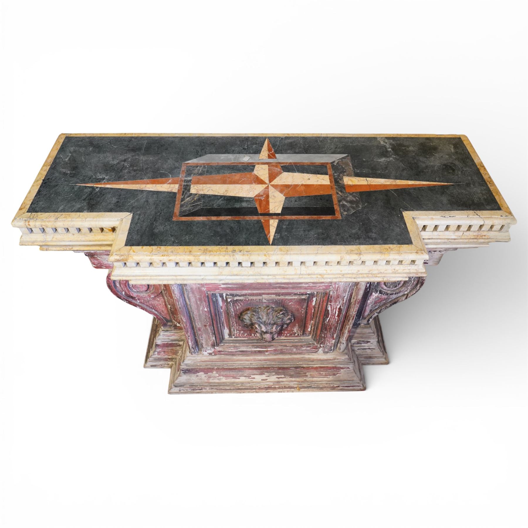 A 20th century Italian Neoclassical console table of monumental architectural form, inspired by Roman altar and sarcophagus prototypes; the rectangular marble top with dentil-moulded edge and polychrome geometric compass-star inlay, executed in contrasting marbles on a dark green ground, above a pedestal base of simulated stone finished in red porphyry-type tones, centred by a lion’s mask in relief and flanked by Ionic scroll volutes, raised on a stepped plinth base