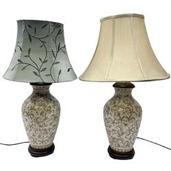 Pair of ceramic table lamps, with foliage decoration and a wooden base H50cm, together with two lampshades. 