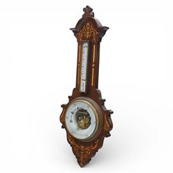 Victorian inlaid rosewood aneroid wall barometer, the circular glass-printed dial with brass bezel, with weather indications for Stormy, Rain, Change, Fair, and Very Dry, with enclosed aneroid movement beneath, shaped case with marquetry scrolls and foliate motifs surmounted by a thermometer with dual Fahrenheit and Centigrade scales, circa 1890-1900