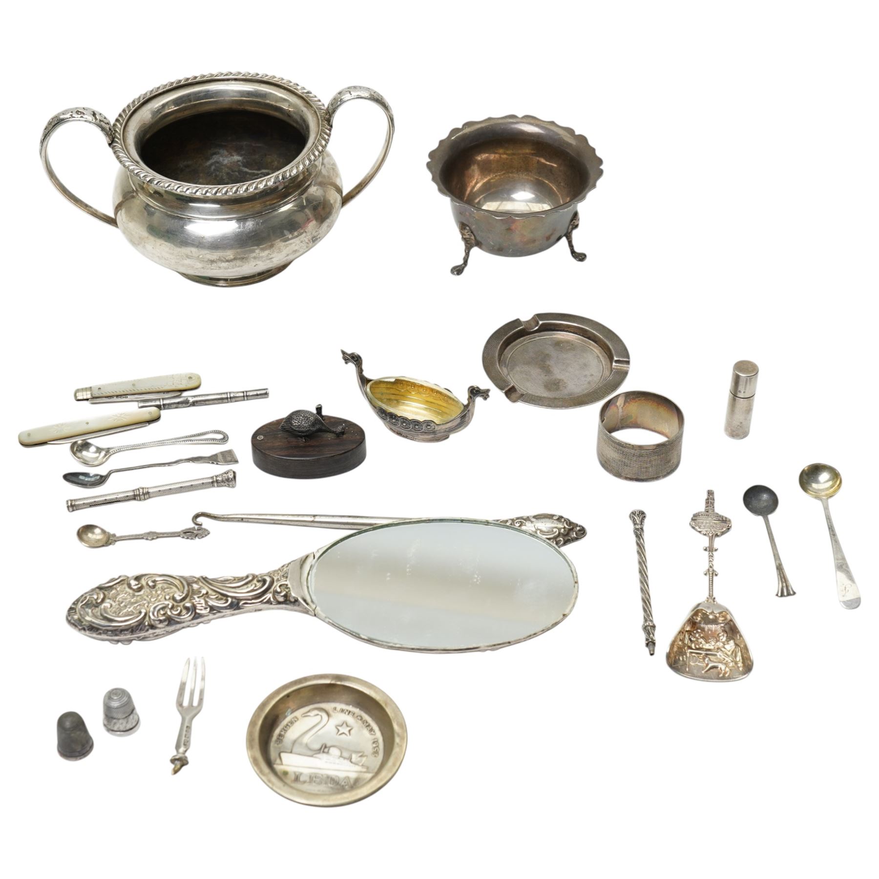 Silver sugar bowl, engine turned silver ashtray, silver napkin ring, silver backed mirror, two silver bladed and mother of pearl fruit knives etc