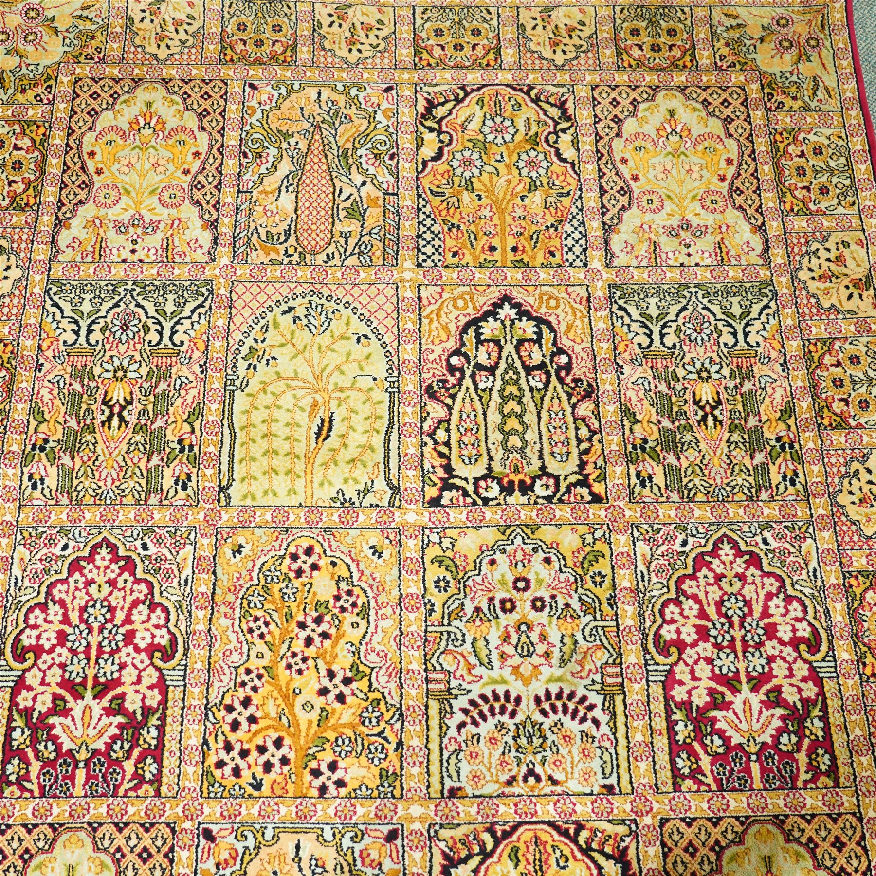 Late 20th-century Persian panel design silk and cotton blend rug, in pale tones of ivory, pistachio, green, crimson, pale blue, and rose, each compartment enclosing a stylized mihrab, boteh, cypress, and floral motifs, framed by a narrow floral border with guard stripes and cotton fringe ends 
