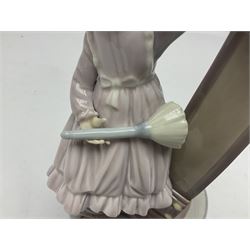 Lladro figure, Bedtime, modelled as a young girl reaching for her pet cat upon grandfather clock, sculpted by Vincente Martinez, with original box, no 5347, year issued 1986, year retired 1998, H28cm