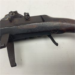 Late 18th/early 19th century flintlock tinder lighter, the steel box lock with hinged door to the left side, fruitwood butt with plain bar trigger, the left side set with a taper sconce and bipod front support, L21cm.