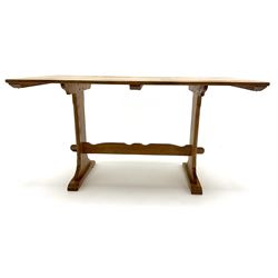 Mid 20th century rectangular oak dining table, shaped solid end supports joined by stretcher on sledge feet 