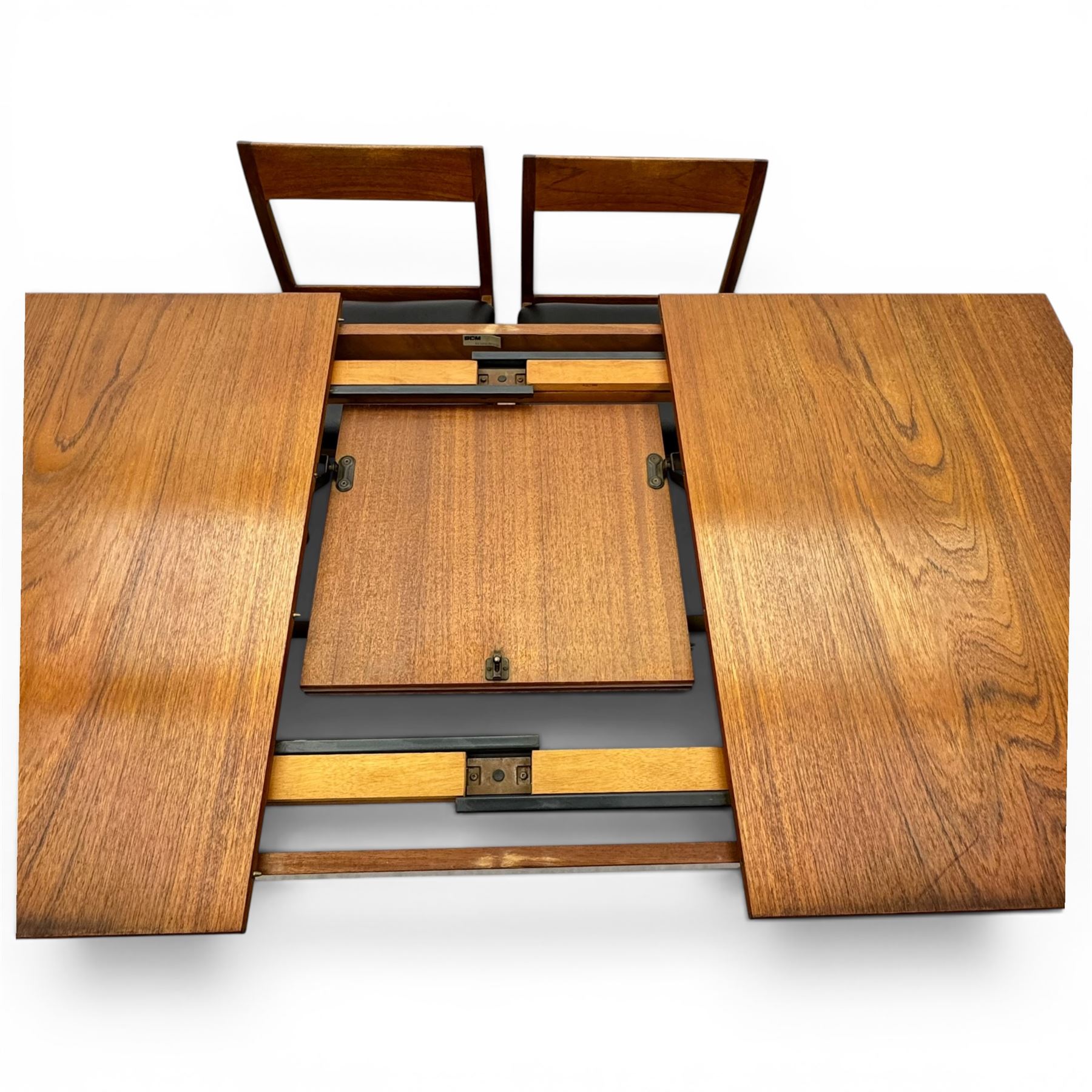 BCM (Bath Cabinet Makers) - mid-20th century teak extending dining table with BCM set of four teak dining chairs with bar back and black vinyl seats