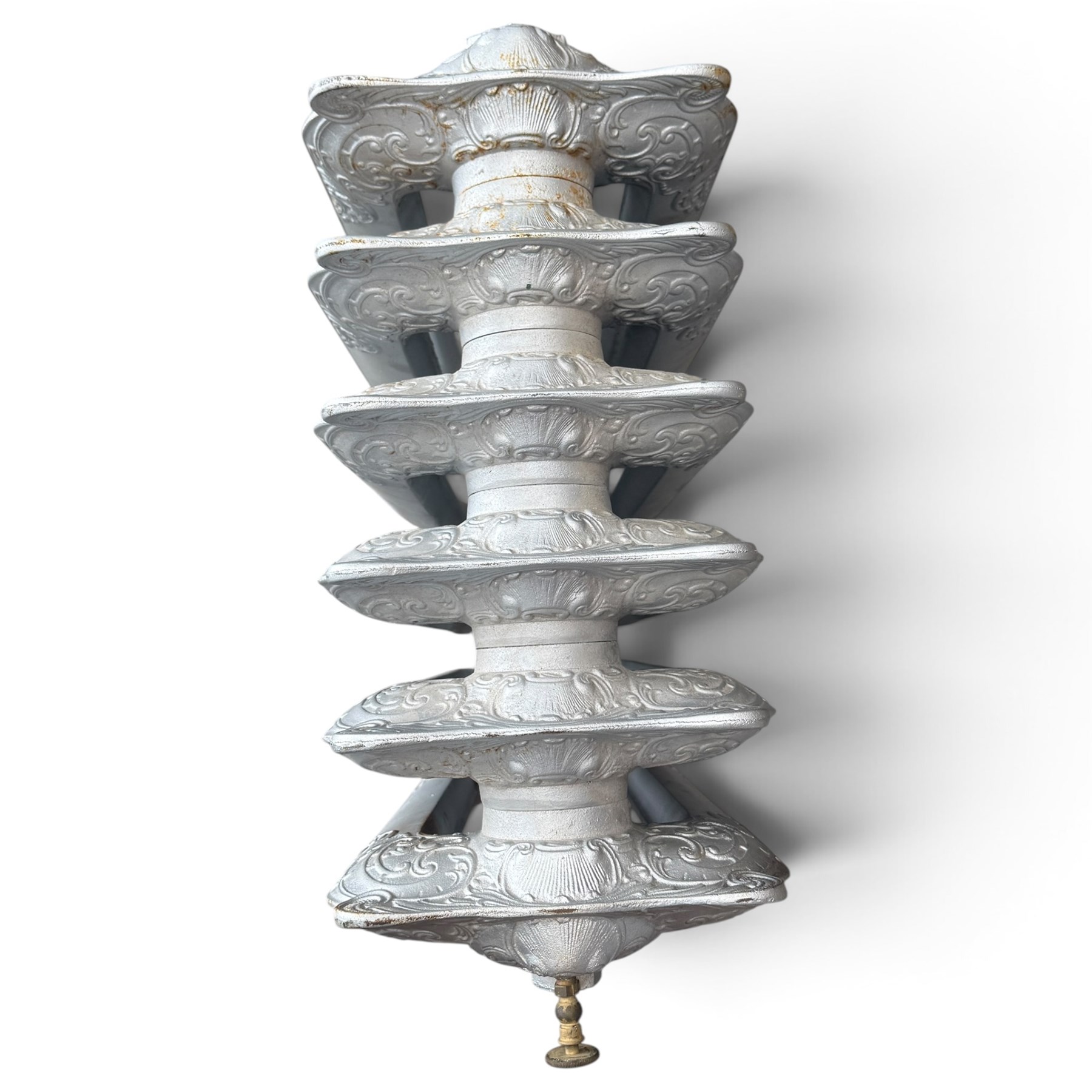 French ornate cast iron column radiator of Rococo Revival design, each section cast with scrolling foliate decoration with rocaille and cartouche motifs, with brass valve and integral bracket feet, in painted silvered finish