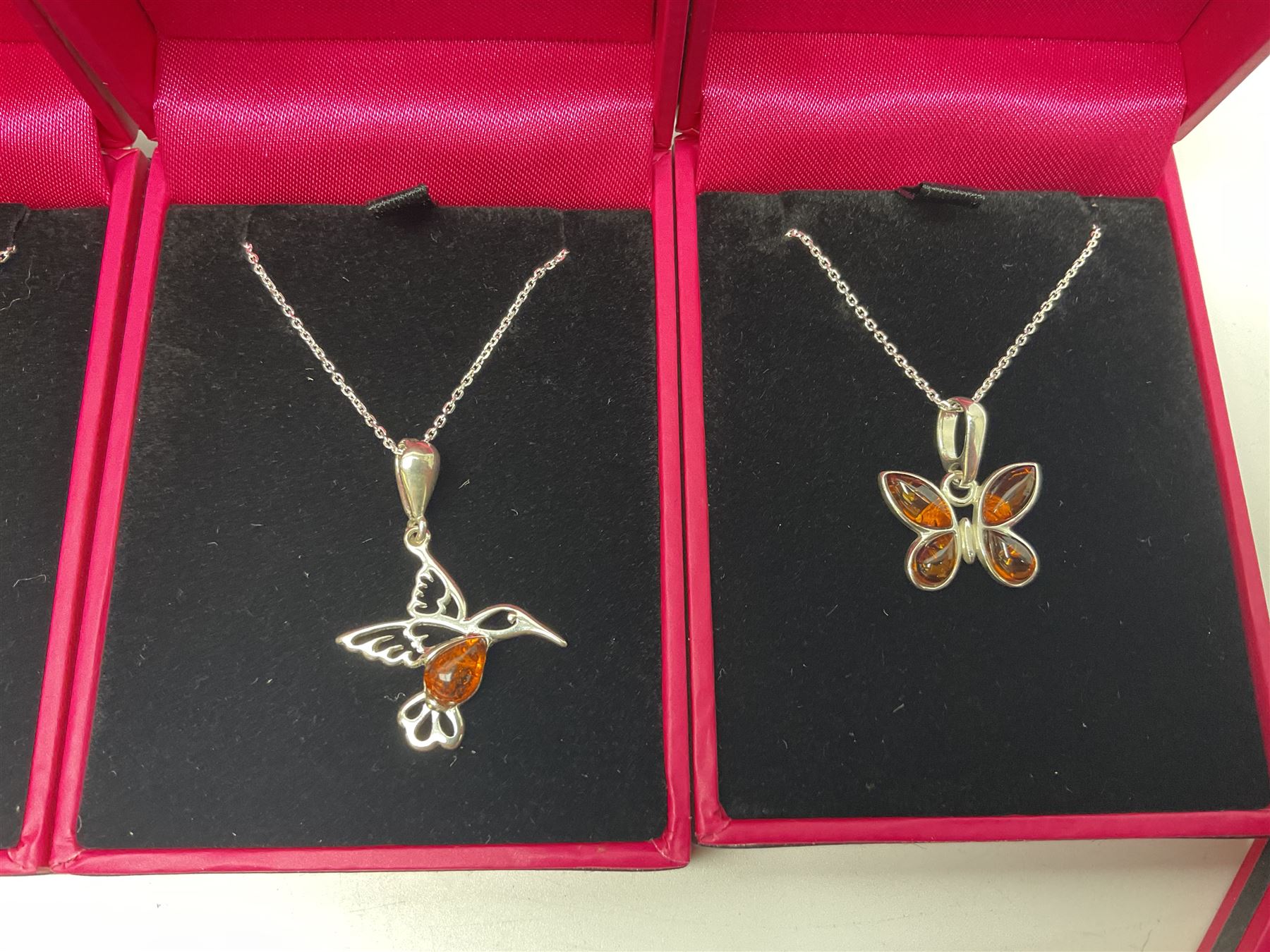 Six silver Baltic amber pendant necklaces, including dinosaur and butterfly designs, all stamped 925 