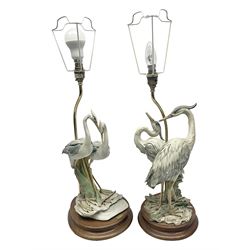 Two Florence table lamps, each lamp depicting a pair of herons upon a wooden circular base, largest H54