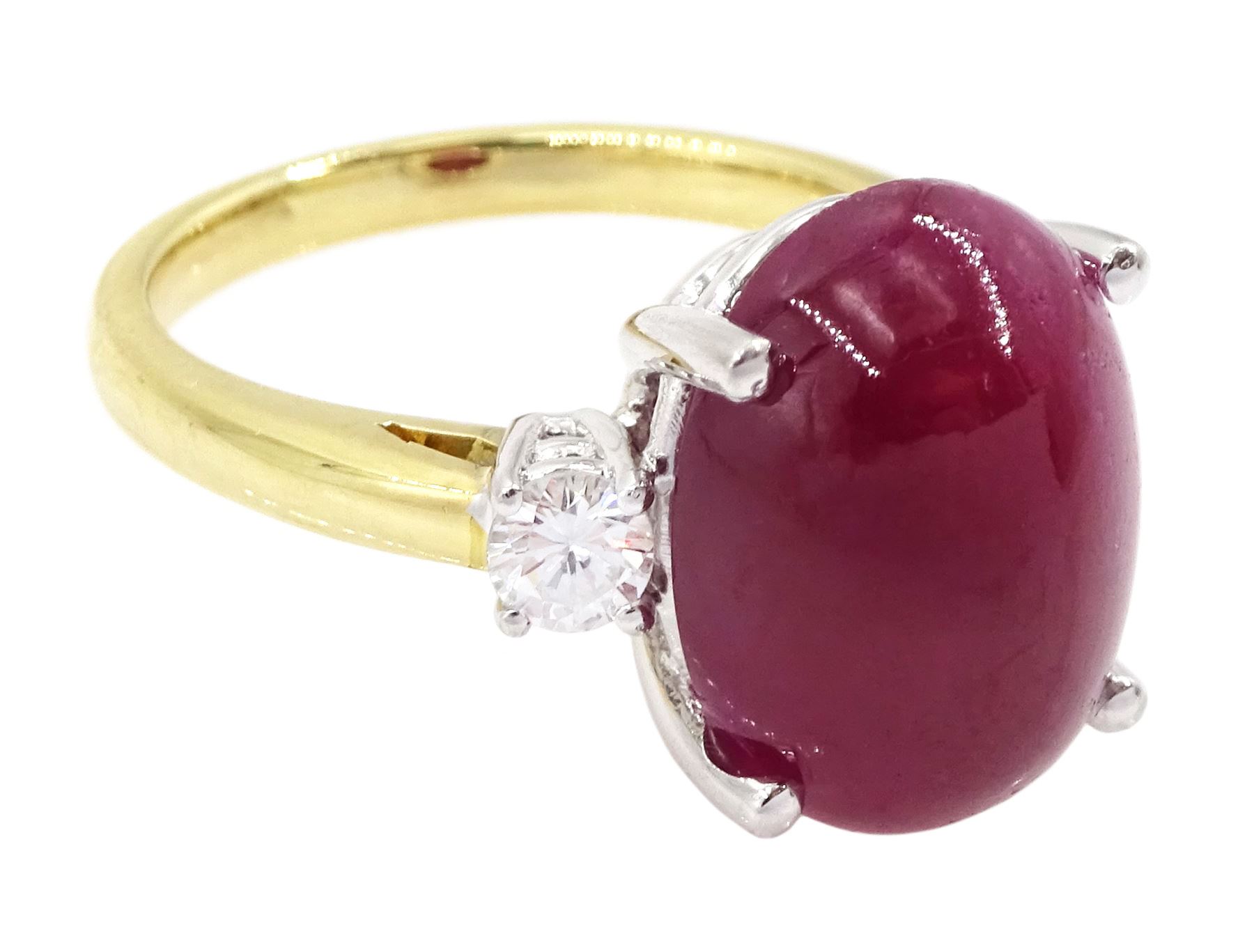 18ct gold ruby and diamond three stone ring, oval cabochon cut ruby of approx 11.40 carat, with a single round brilliant cut diamond set either side, hallmarked