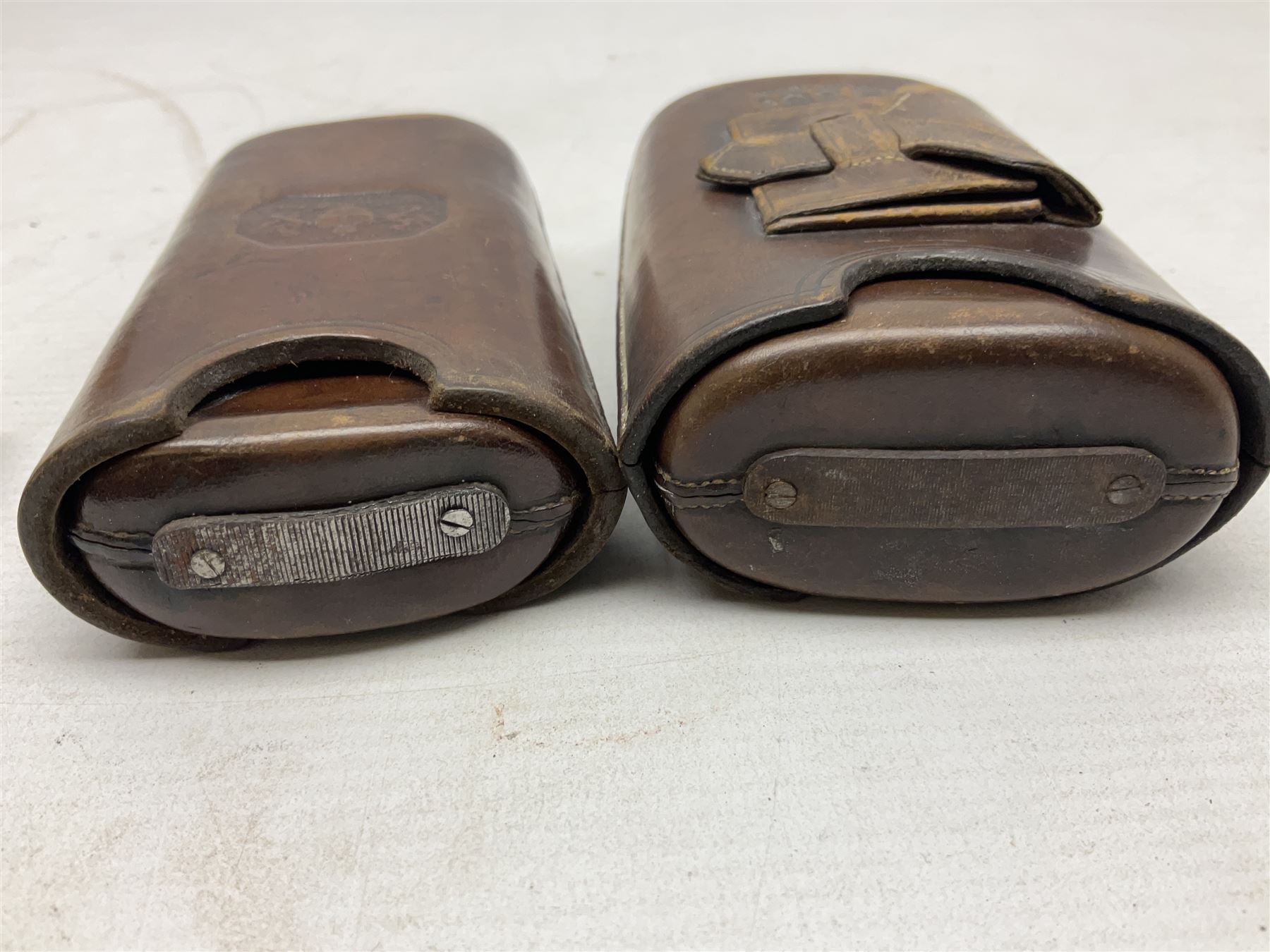 Victorian leather cigar protector with metal match striking plate on the end and internal spring to hold the cigars in place; expands for differing lengths of cigar, minimum L12.5cm; another similar leather cigar case marked Middlemore's Patent with attached vesta case and striker; three Bryant & Mays tin-late matchbox holders including 1935 Jubilee; and small box of matches (6)