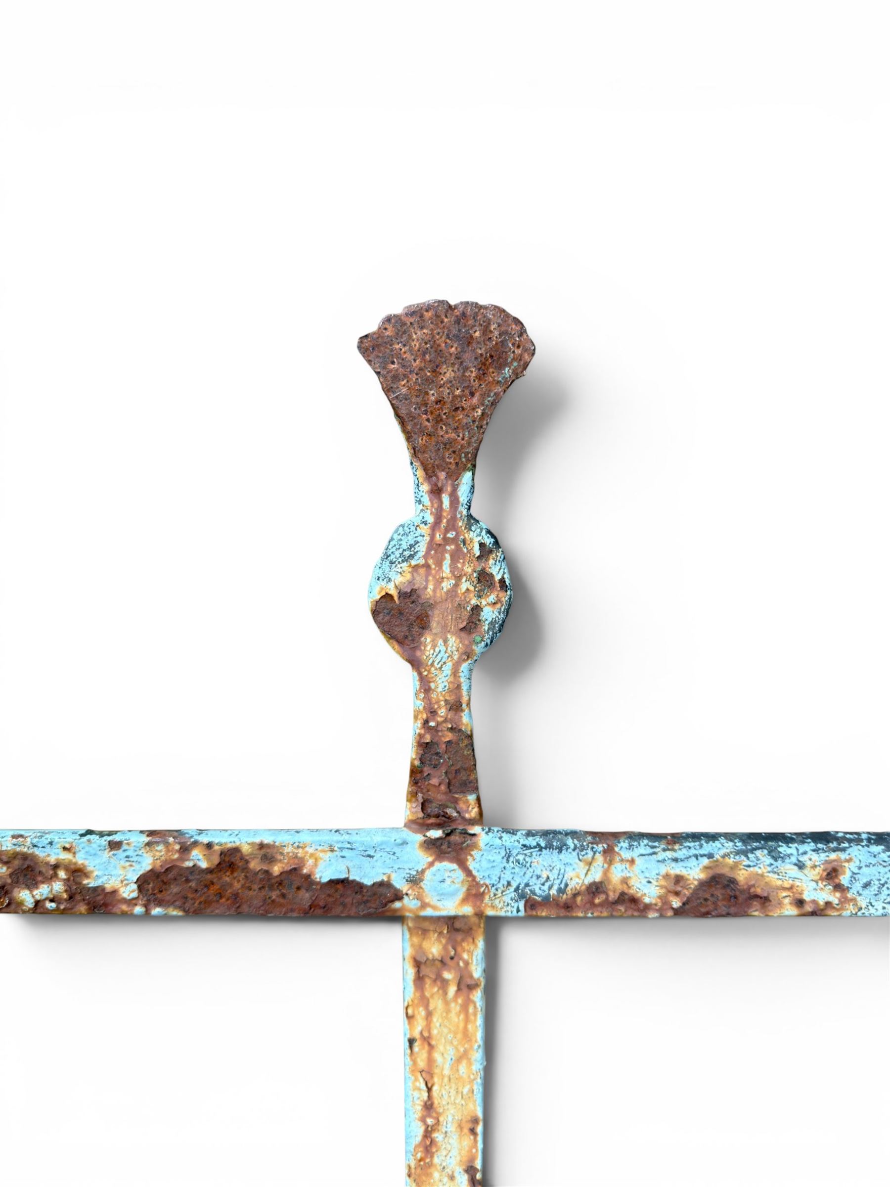 Regency period wrought iron strapwork garden bench, cresting rail with central Scottish thistle motif and flanking pediments, in distressed blue painted finish