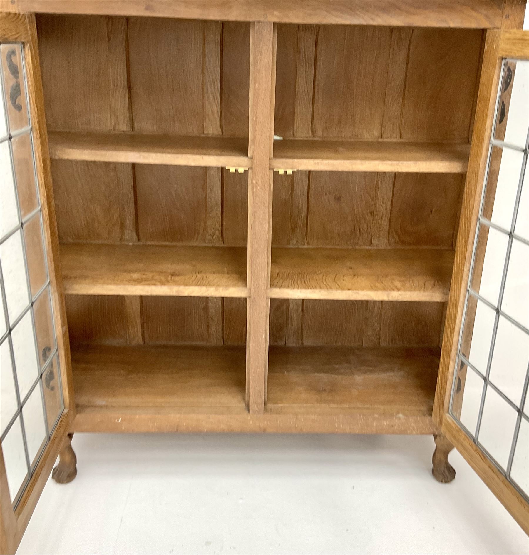 David 'Oakleaf man' Langstaff of Easingwold Yorkshire oak cabinet, egg and dart detailing, with two lead glazed doors enclosing two shelves, bearing oak leaf signature, cabriole claw feet