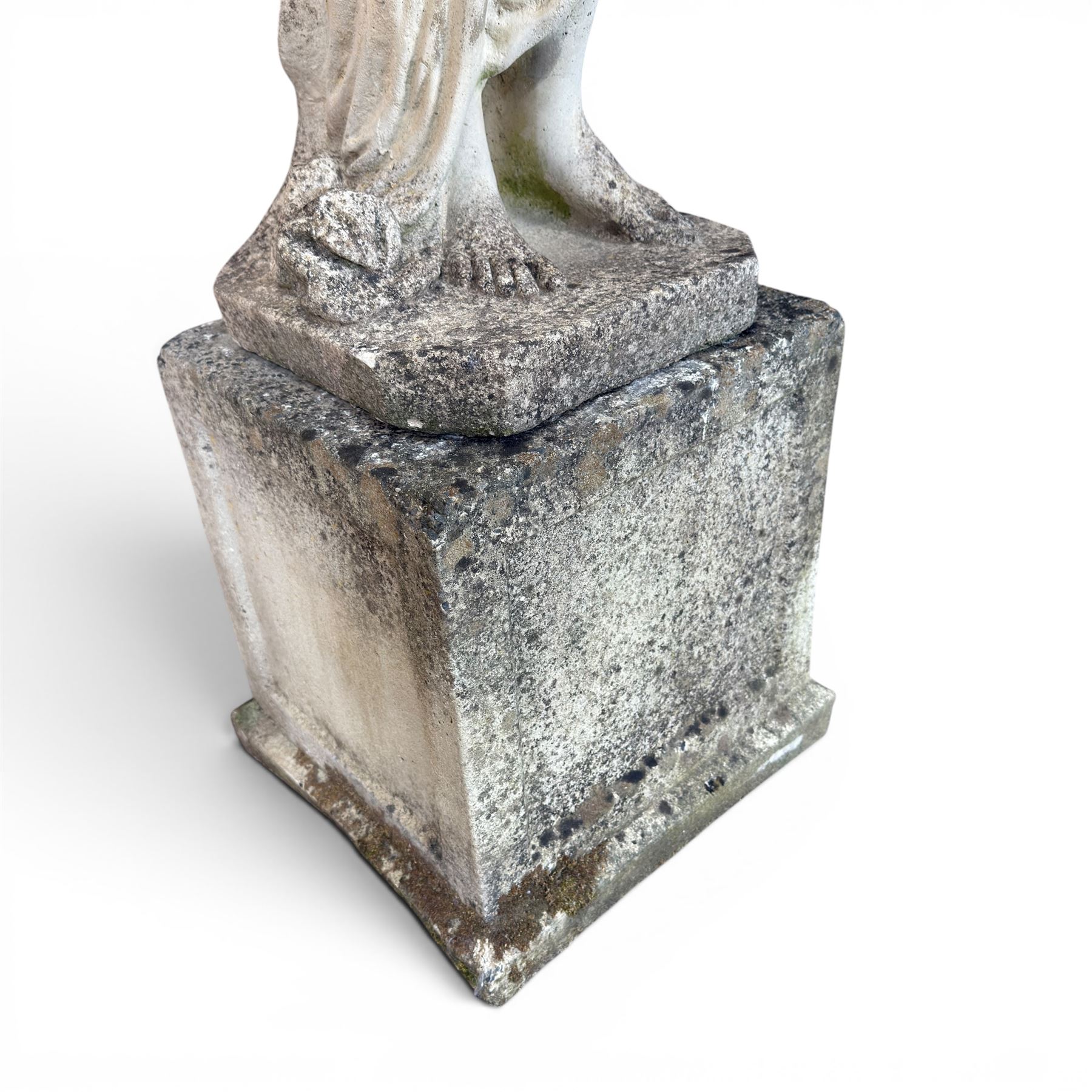 Weathered cast stone garden statue of a 'Shy Maiden', raised on square plinth base