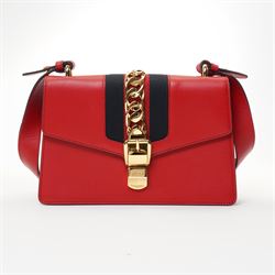 Gucci - ‘Sylvie’ Small Shoulder Bag, introduced circa 2016 under Alessandro Michele, in red calfskin leather with signature web stripe, gold-tone chain and buckle fastening and hardware, flat leather shoulder strap with alternative web-stripe grosgrain strap, unused with original dust bag