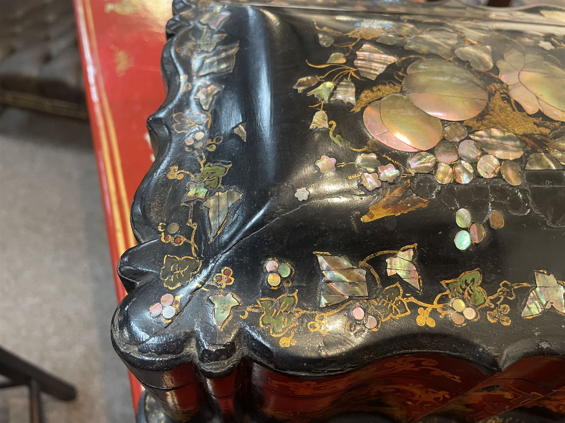 Victorian black lacquered papier-mâché sewing box, of rectangular form with shaped sides, the slightly domed top with inlaid mother of pearl and abalone decoration, the sides with gilt and polychrome painted scrollwork, the hinged cover opening to reveal a fitted interior with lift out tray, H14cm