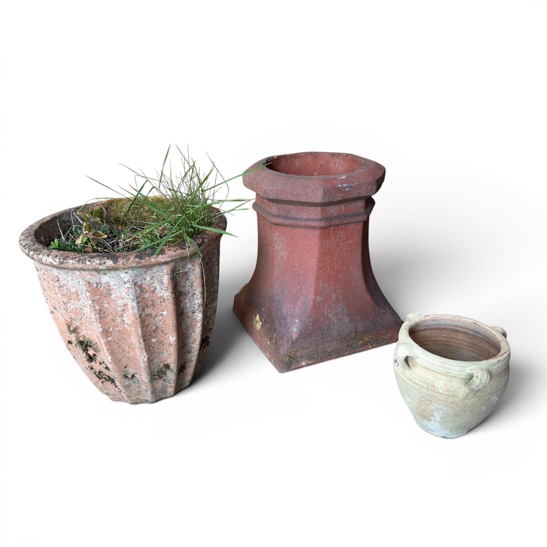 Two Victorian terracotta octagonal squat chimney pots, three other pots, terracotta planter, three small planters, cast iron fox door stop and a cherub wall pocket