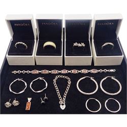 Silver and silver stone set jewellery including four boxed Pandora rings, three pairs of hoop earrings and an amber pendant, all stamped or tested