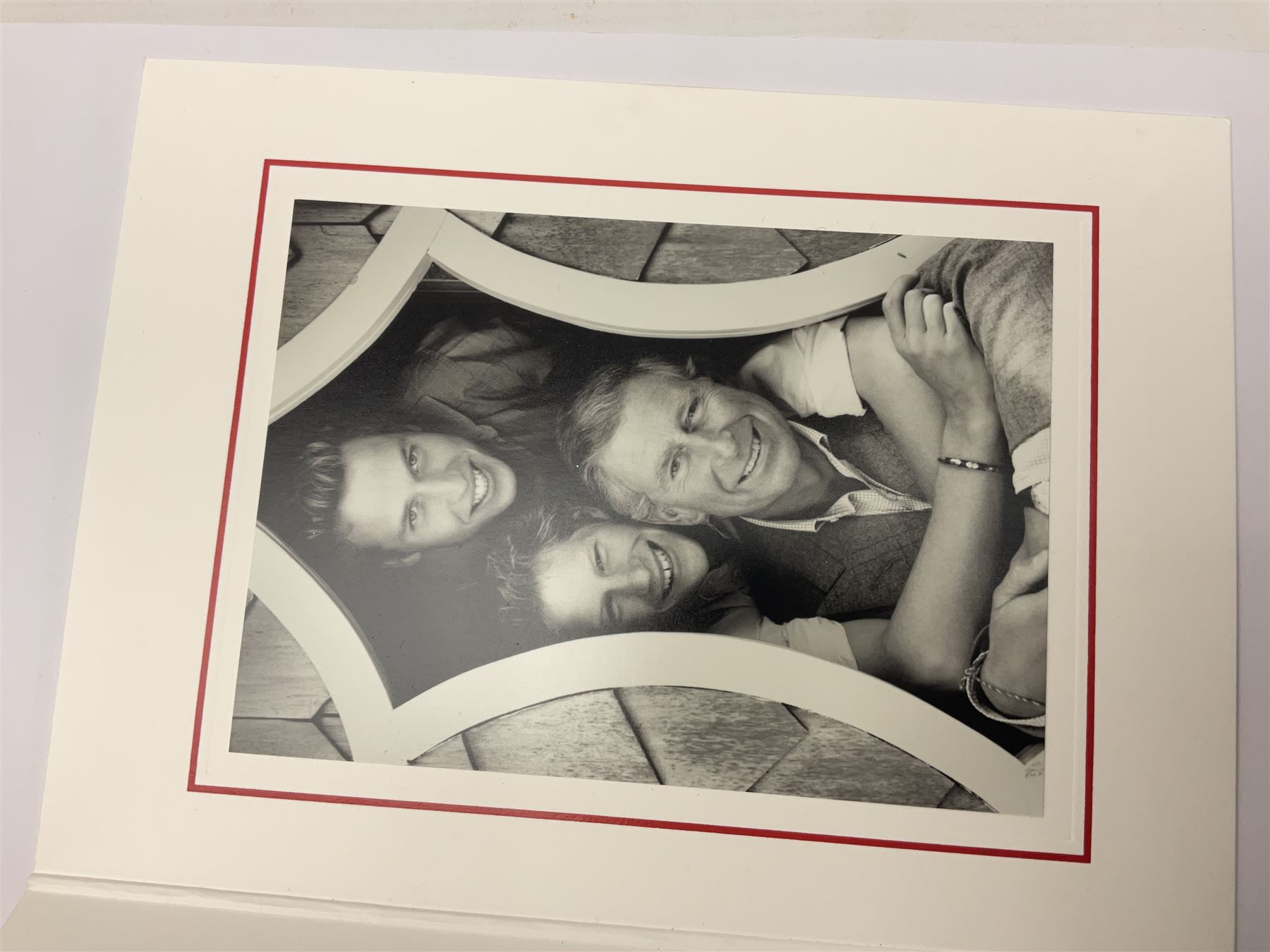 2003 Royal Christmas card with gilt embossed Prince of Wales crest to cover, the interior with black and white photograph of a smiling Prince Charles, now King Charles III, Prince William and Prince Harry, signed in autopen 'from Charles', with indistinct name to top