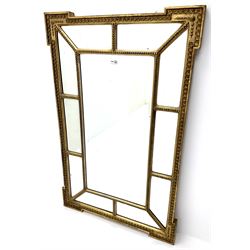 Contemporary gilt framed mirror, rectangular bevelled mirror to centre surrounded by segmented bevelled mirror panels, in bead and anthemion moulded frame