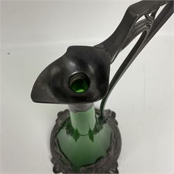 Early 20th century WMF Art Nouveau pewter and green glass ewer, of swept cylindrical form, having a pierced stopper and handle of entwined stems and berry design, the base cast as water nymphs with flowing hair and lily pads, H38cm