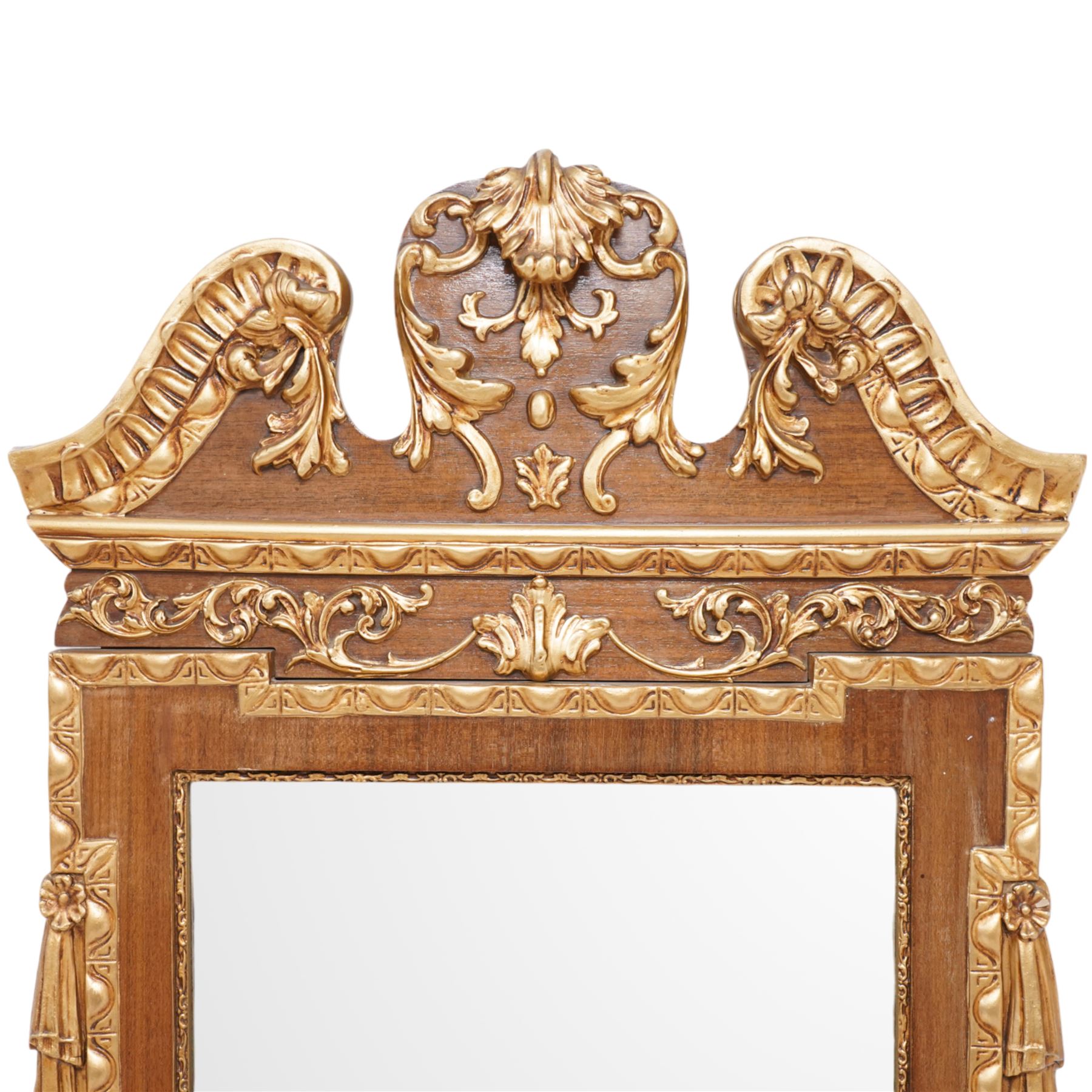 20th-century ornate gilt and mahogany Chippendale style wall mirror, the wooden gilt-edged frame with applied scrollwork with foliate motifs, drape, and tassel decoration 