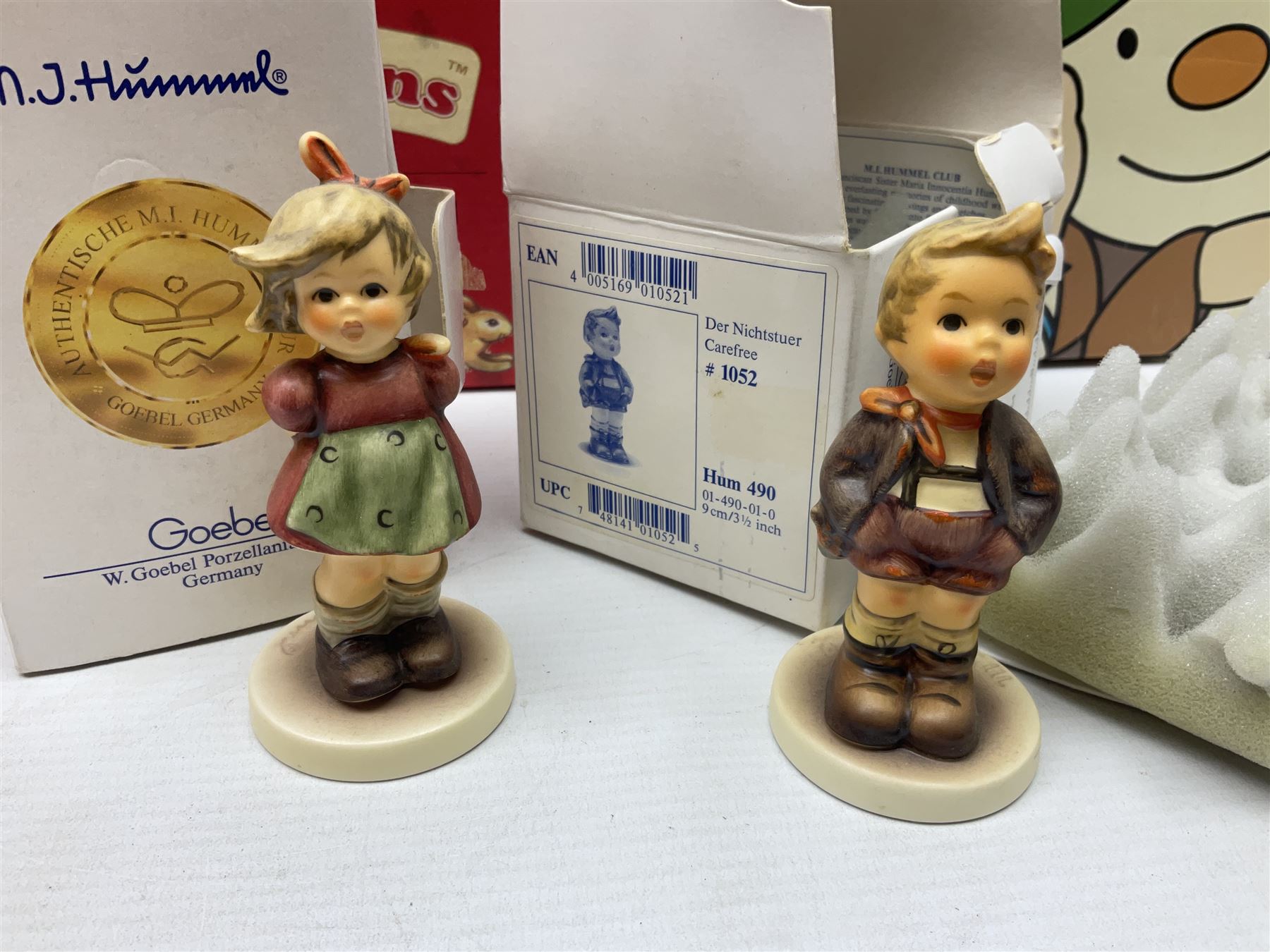 Royal Doulton The Mickey Mouse Collection Pluto figure, Coalport Characters The Snowman Dressing Up figure, three Royal Doulton Bunnykins figures comprising Policeman, Morris Danger and Eskimo, and display stand, Royal Doulton John Beswick Tiggy Winkle, Royal Albert Beatrix Potter Peter Postbag and three Goebel Hummel figures, all boxed