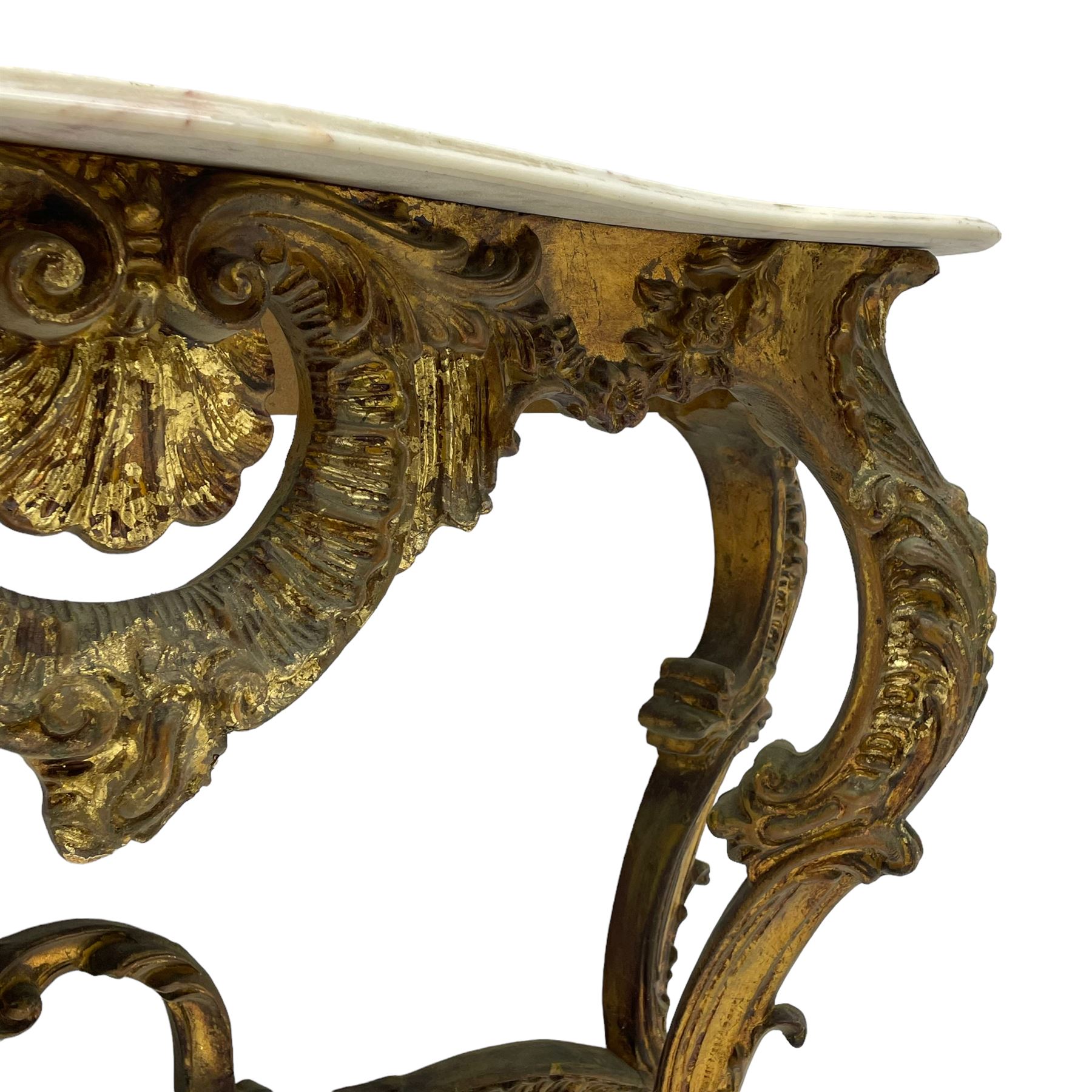 French Rococo design console or pier table, shaped and moulded pale marble top, the apron carved with pierced shell and scrolling acanthus leaves, extending flower head decoration, on four acanthus carved cabriole supports with scrolled terminals, united by shell moulded stretcher rails with central scrolled foliage cartouche 