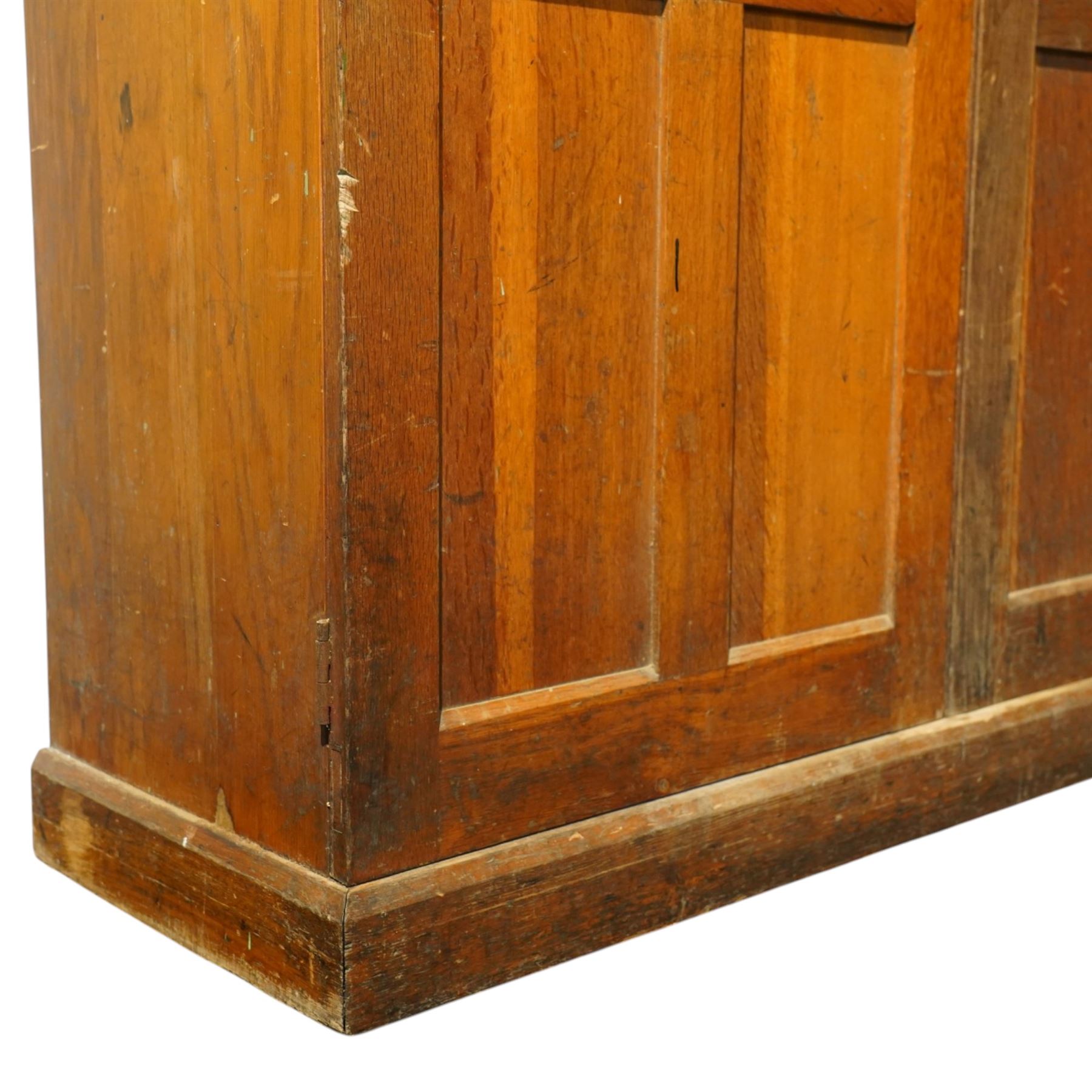 Early 20th century Arts and Crafts oak housekeeper’s cupboard, moulded cornice above pair of panelled doors enclosing a shelved interior, on plinth base