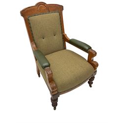 Late 19th century walnut framed armchair, cresting rail carved with cartouche and Greek key design, seat and back upholstered in green tweed fabric, arms upholstered in green leather with studwork, arm terminals carved with foliate and scrolled decoration, raised on turned supports with brass and ceramic castors
