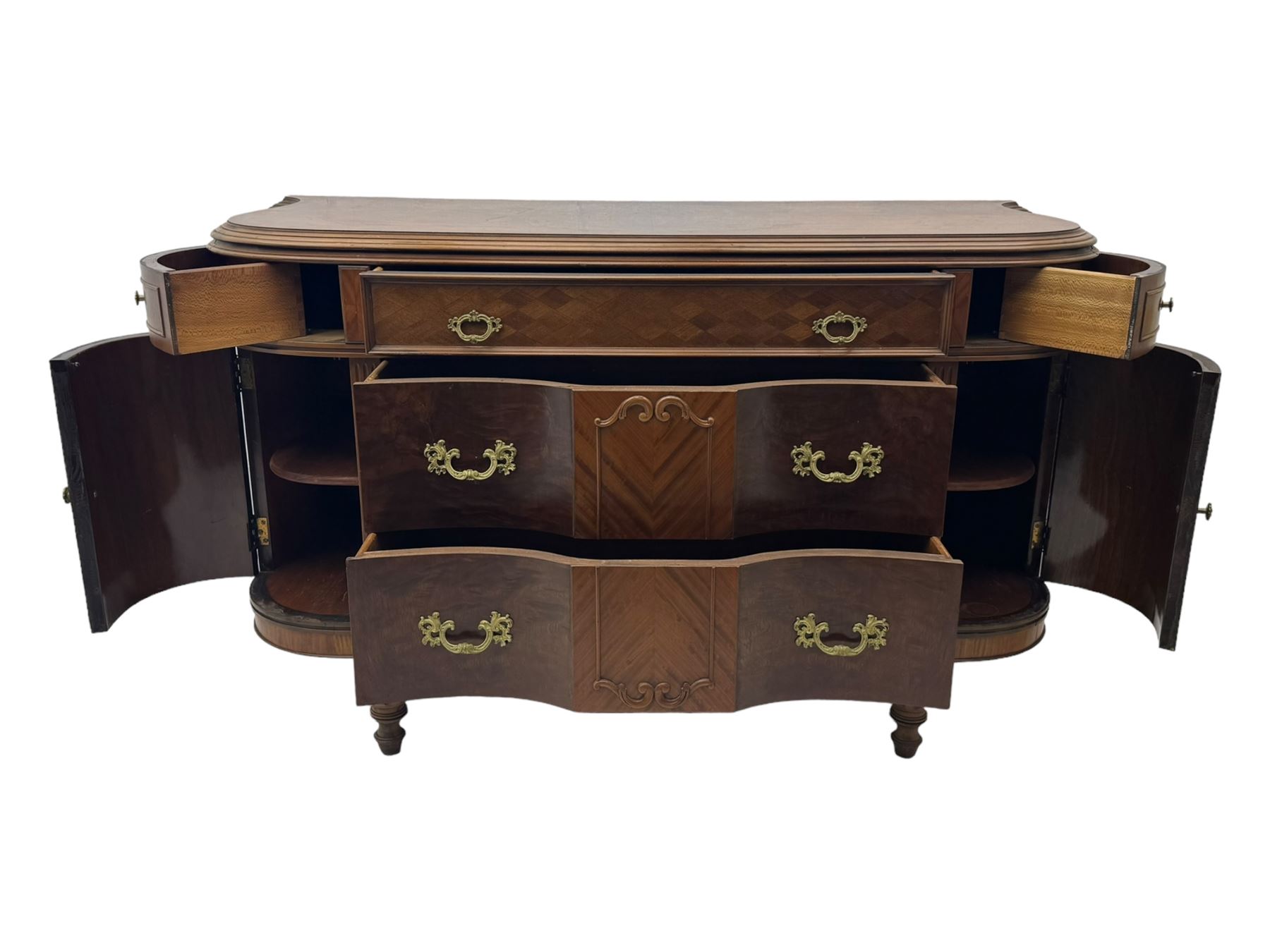 Late 20th century Italian walnut sideboard, serpentine front and bow-shaped top with highly figured veneer, single checkered-pattern frieze drawer over two drawers with central foliage cartouche, flanked by hinged frieze drawers over cupboards, on turned and carved supports