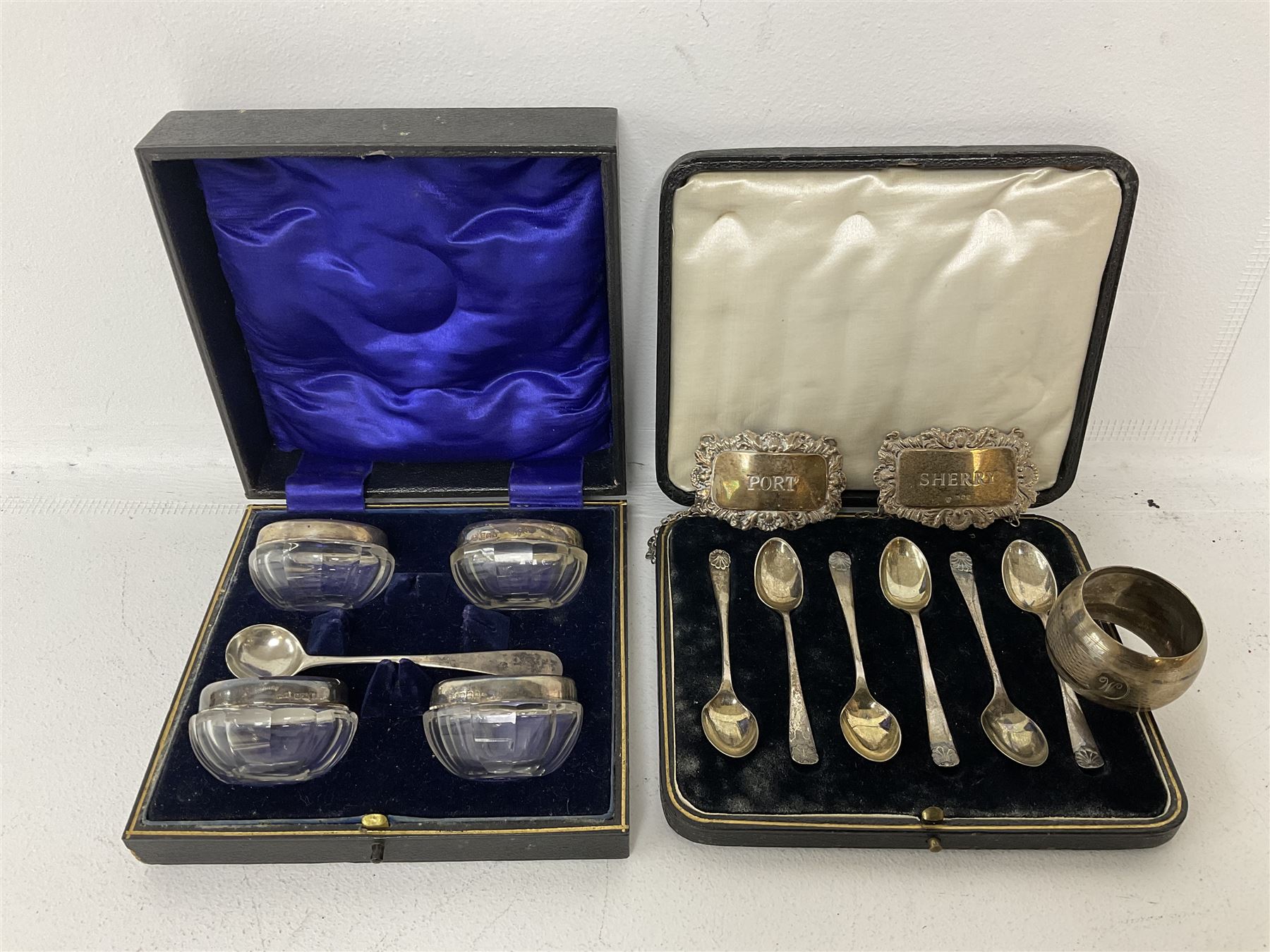 Cased set of six spoons by Cooper Brothers & Sons, two hallmarked silver decanter labels, four silver collared glass salts in box, further silver spoon and napkin ring