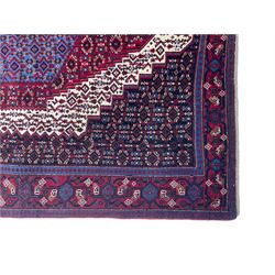 Persian Senneh rug, red ground with stepped lozenge medallion, decorated all-over with stylised motifs