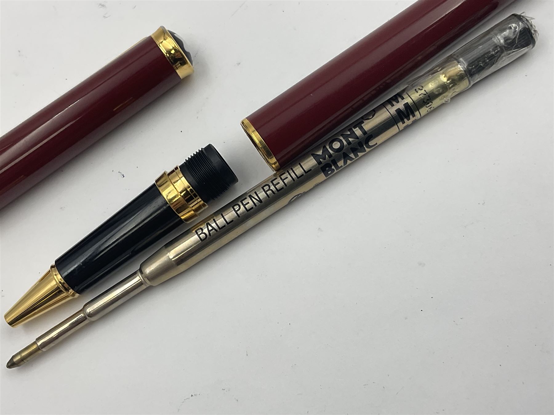 Montblanc Noblesse Oblige fountain pen, the maroon barrel and cap with gilt clip and mounts and nib stamped 585 14K/ct, together with a matching ballpoint pen, largest L14cm (2)