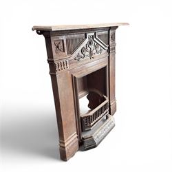 Late Victorian cast ion bedroom fireplace, decorated with floral poppy motifs and flluting