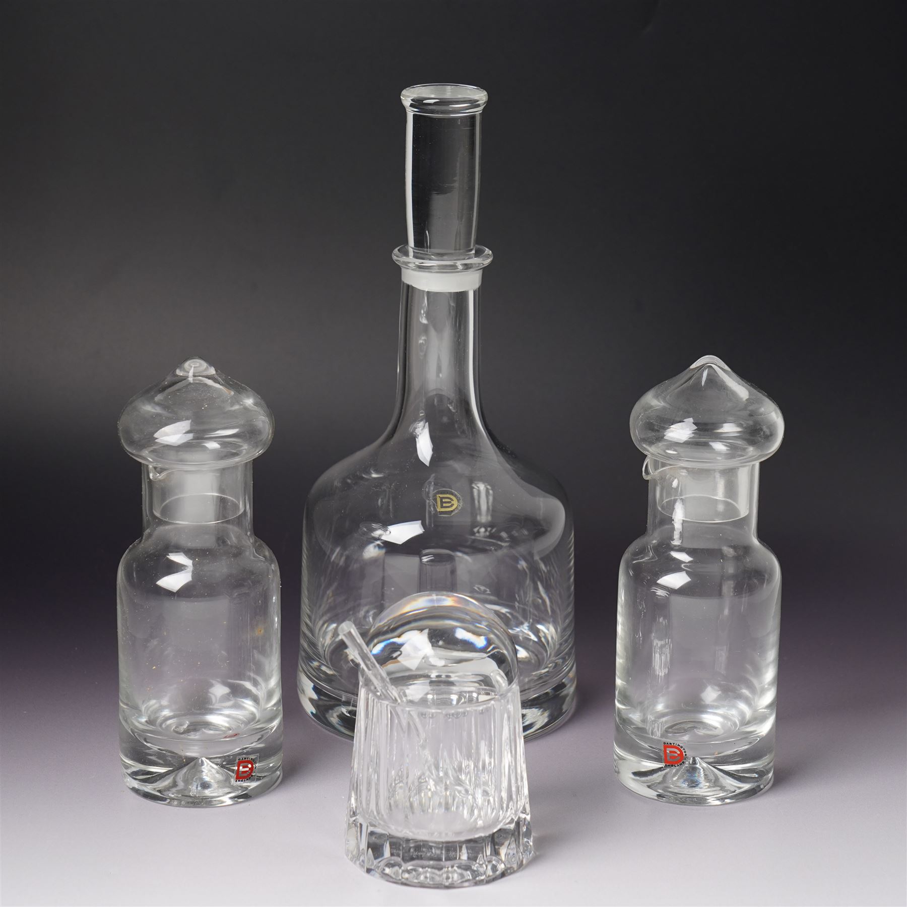 Three Dartington Crystal examples designed by Frank Thrower, comprising two oils and vinegar bottles, and one decanter, together with a covered jar with spoon designed by Palona Picasso for Villeroy & Boch, all boxed (3)