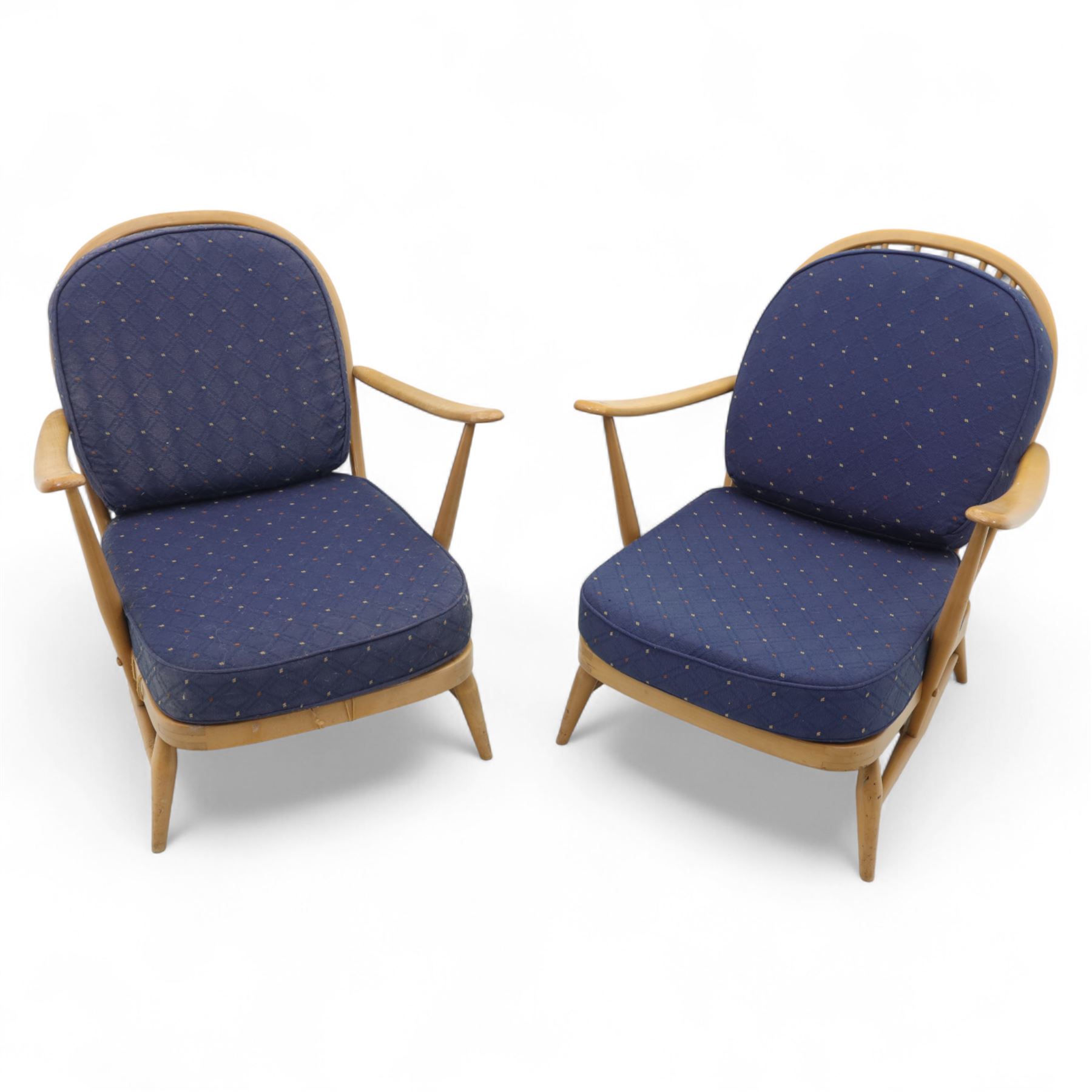 Ercol - Model '203', pair of easy chairs, with blue upholstered cushions and additional orange covers, with looped backrest and shaped spindles, outward swept arms, drop in seat frame