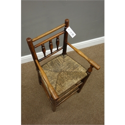  18th century elm and fruitwood child's high chair, spindle back, rush seat, well worn foot stretcher, H81cm  