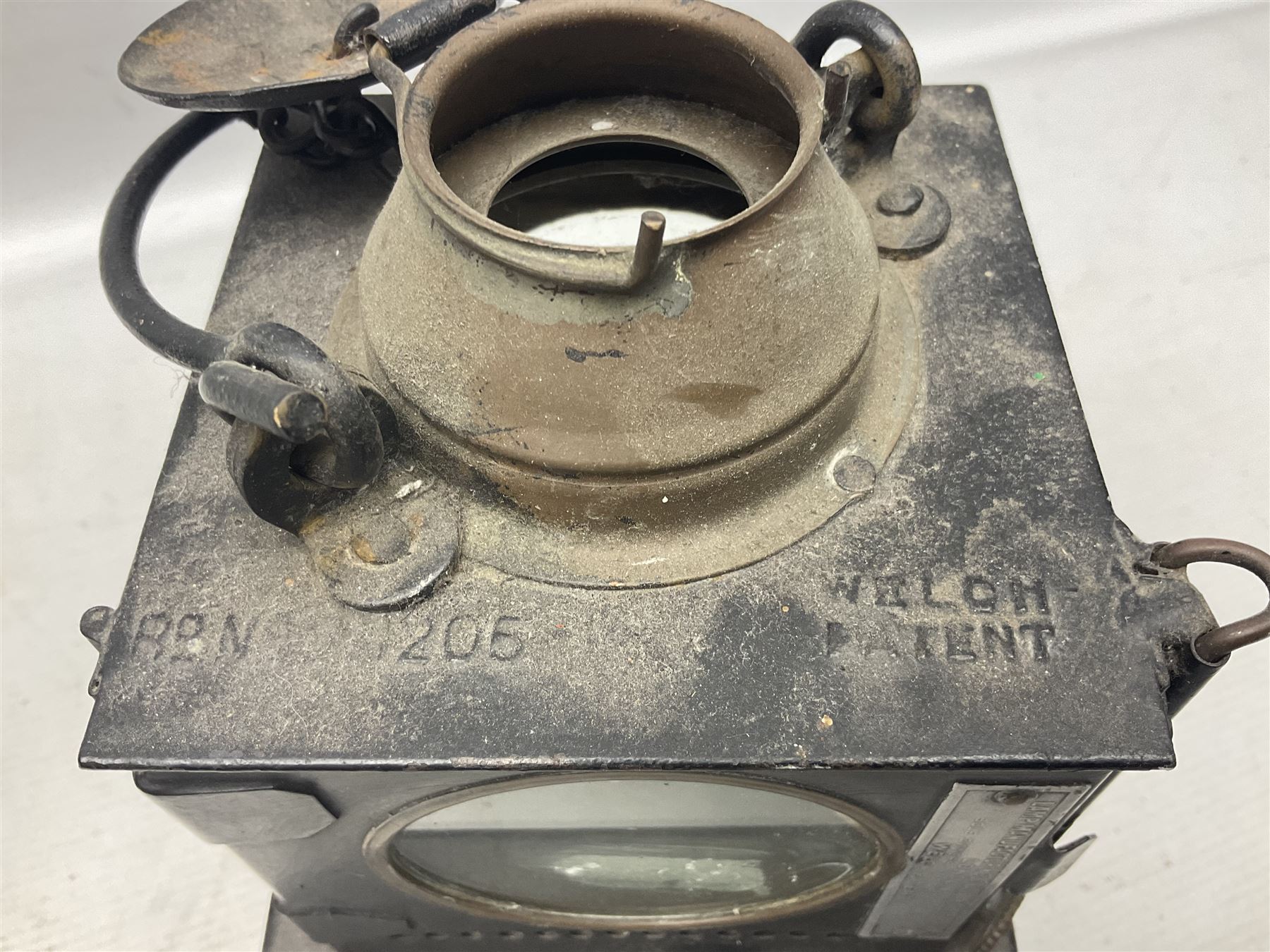 Railway interest - Lamp Manufacturing & Railway Supplies Ltd  Welch patent BR(E) lamp (M), with hinged copper upper section and hinged side door with maker's label, on square base H24cm; and another railway inspection type lamp (2)