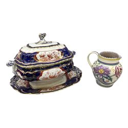 Early 20th century Poole jug, decorated with flowers in purple, blue and pink, with an upper geometric banded rim, no. 603, impressed and painted marks beneath, H14cm, together with a 19th century Booths lidded tureen and stand in the Victoria pattern