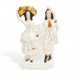 Staffordshire pottery figures including watch stand with piper and companion, pair of dogs and pups, pair of fish sellers and two others