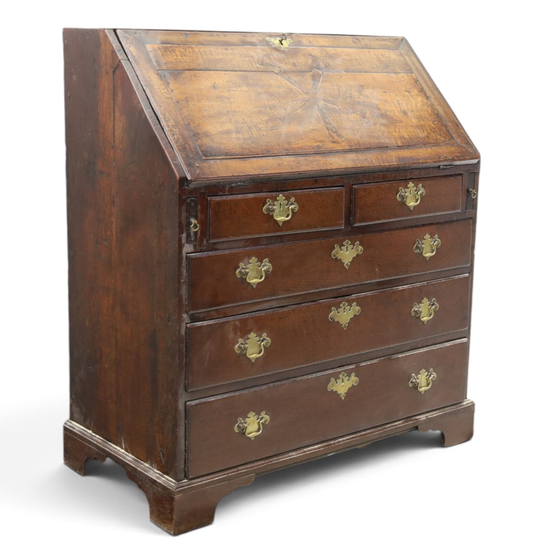 18th century inlaid oak bureau, the fall-front with central star inlay enclosing fitted interior with central cupboard flanked by fluted column correspondence drawers and pigeon holes, over two short and three long drawers, lower moulded edge on bracket feet