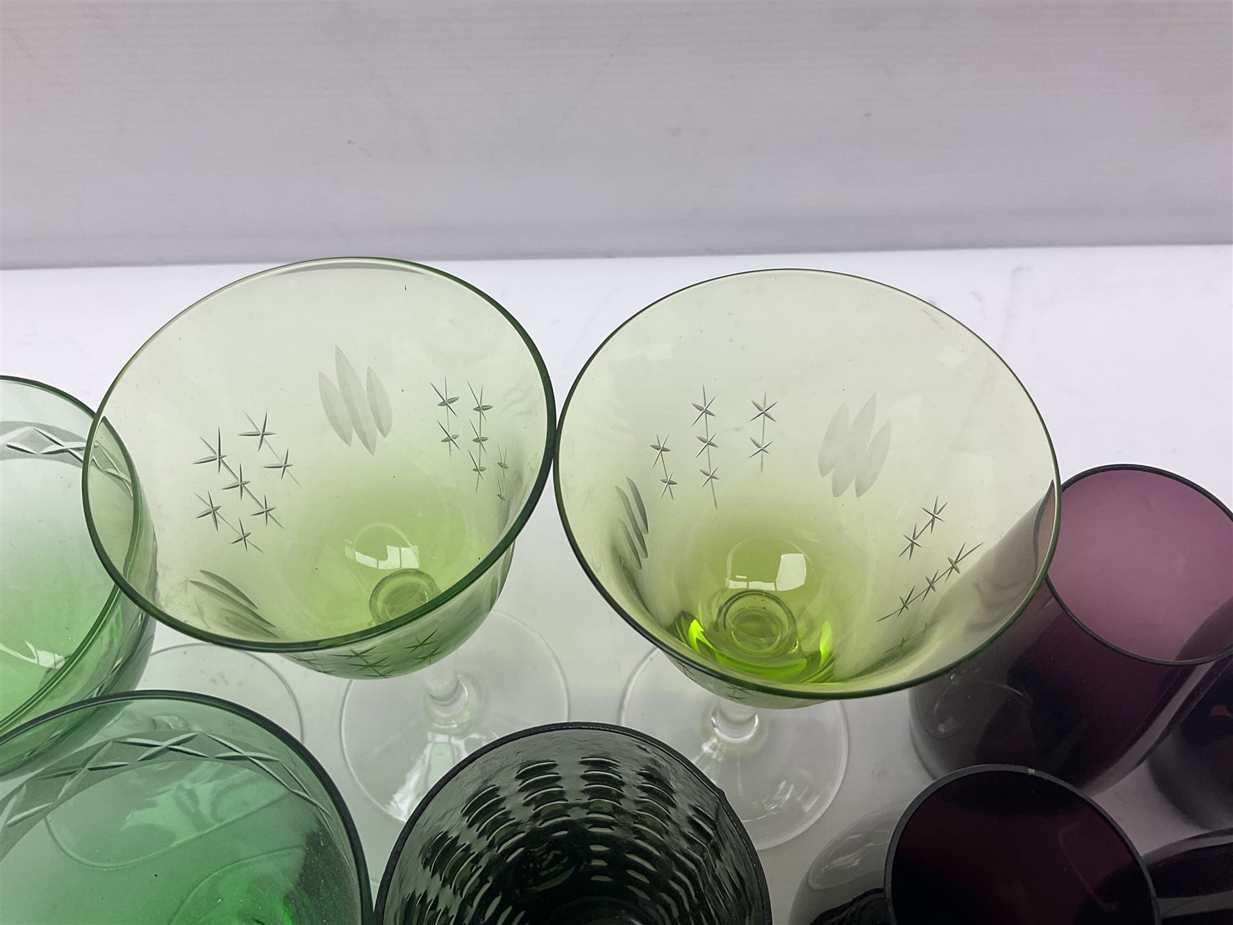 Set of four Swedish Reijmyre drinking glasses, with textured outer surface, together with green drinking glasses including Holmegaard examples and other glassware