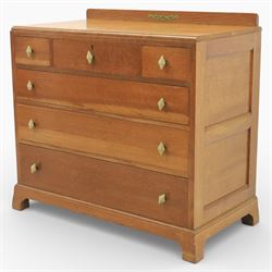 Early 20th century Art Deco bedroom suite, comprising double wardrobe, dressing table and chest of drawers, constructed in walnut with figured veneers and geometric banding, the wardrobe with arched top and panelled doors enclosing a fitted interior, the dressing table with rectangular top below a three panel mirror arrangement, fitted with two short over two long drawers, the chest with three short and three long drawers, each piece fitted with faceted handles and raised on shaped feet
Wardrobe (H 177cm, D 46cm, W 112cm)
Chest (H 85cm, D 48cm, W 92cm)
Dressing table (H 160cm, D 52cm, W 106cm)
