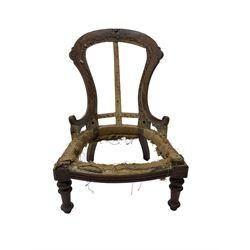 Late Victorian walnut and beech framed nursing chair, with carved scroll decoration, on turned supports 