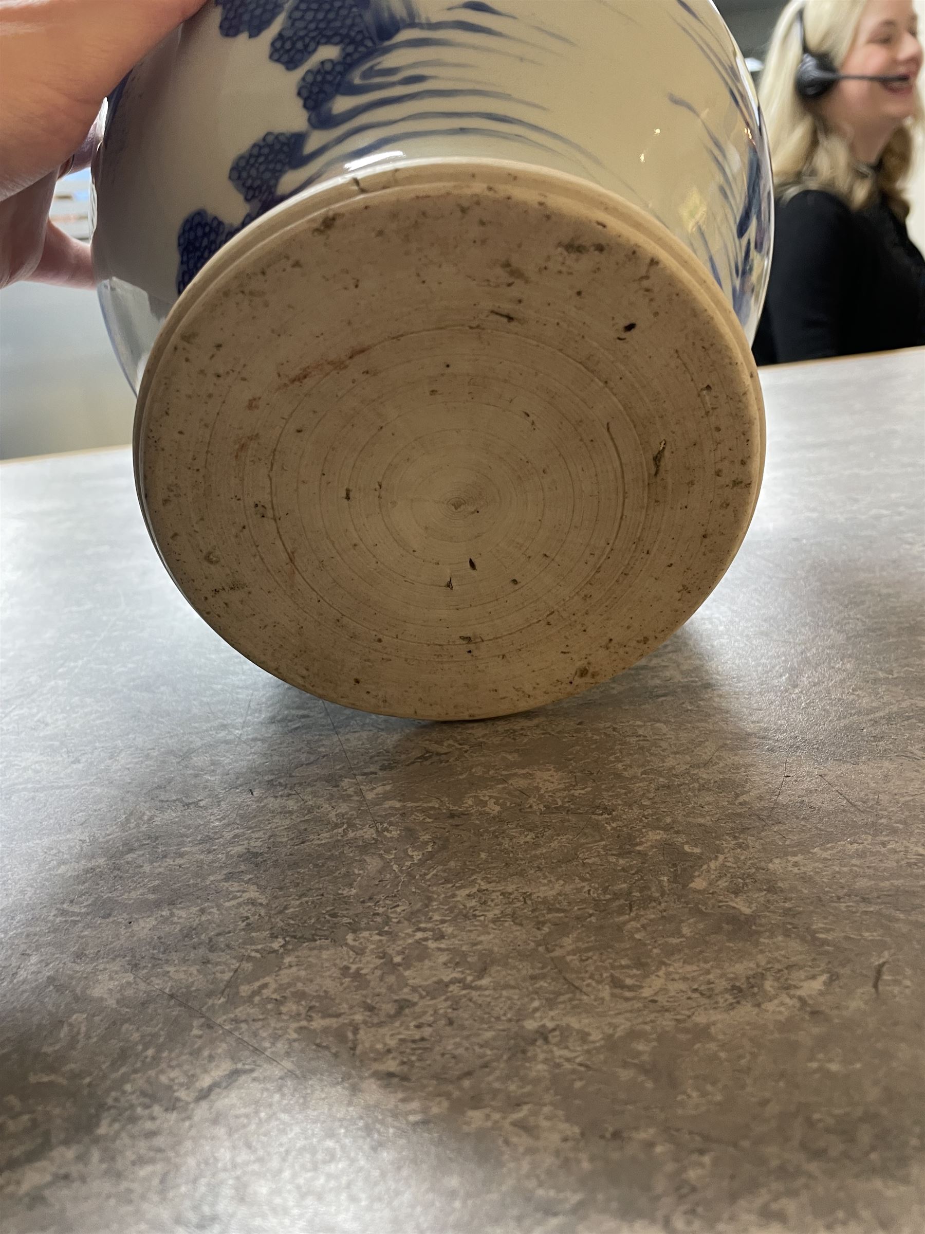 Pair of Chinese Kangxi blue and white porcelain vases, each of baluster form, painted with an outdoor scene containing figures seated upon the ground reading scrolls and holding fans, willow and bamboo tress, rock work and water, H27cm