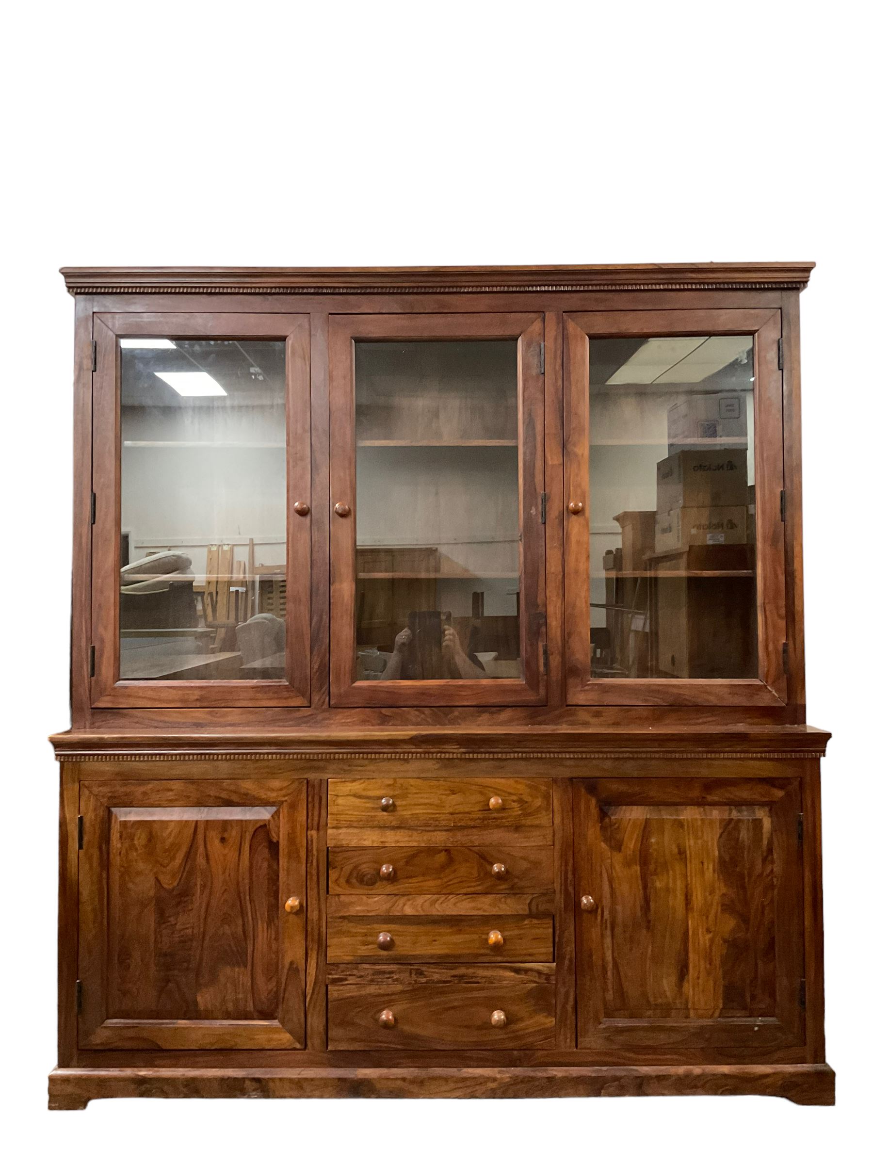 Large hardwood display wall unit, the upper section fitted with three glazed doors enclosing six shelves, the lower section fitted with four central drawers flanked by two panelled cupboards